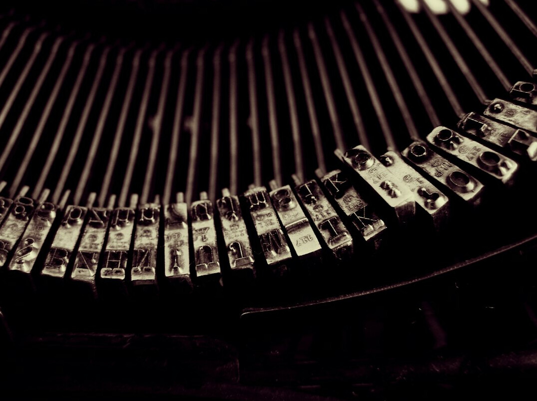 writer typing on old typewriter